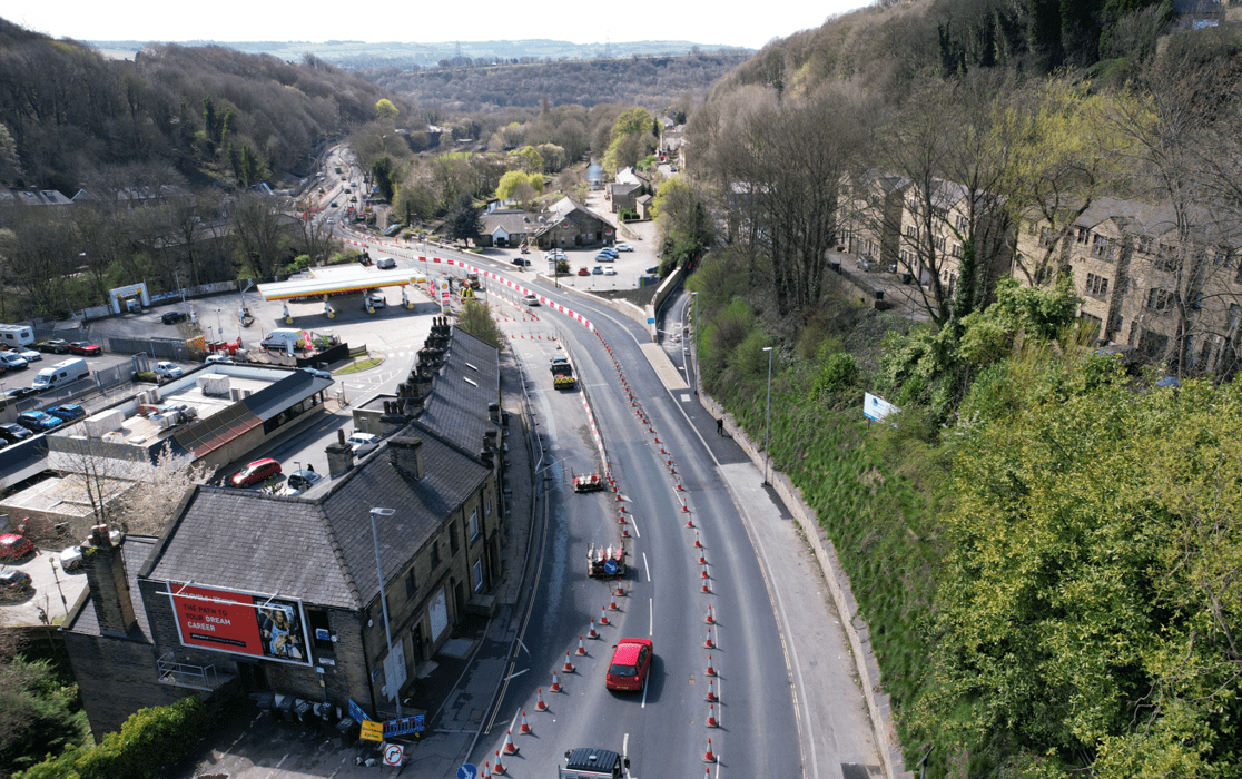 View looking over the northern extent of the site showing vehicles travelling through the area while work is in progress.