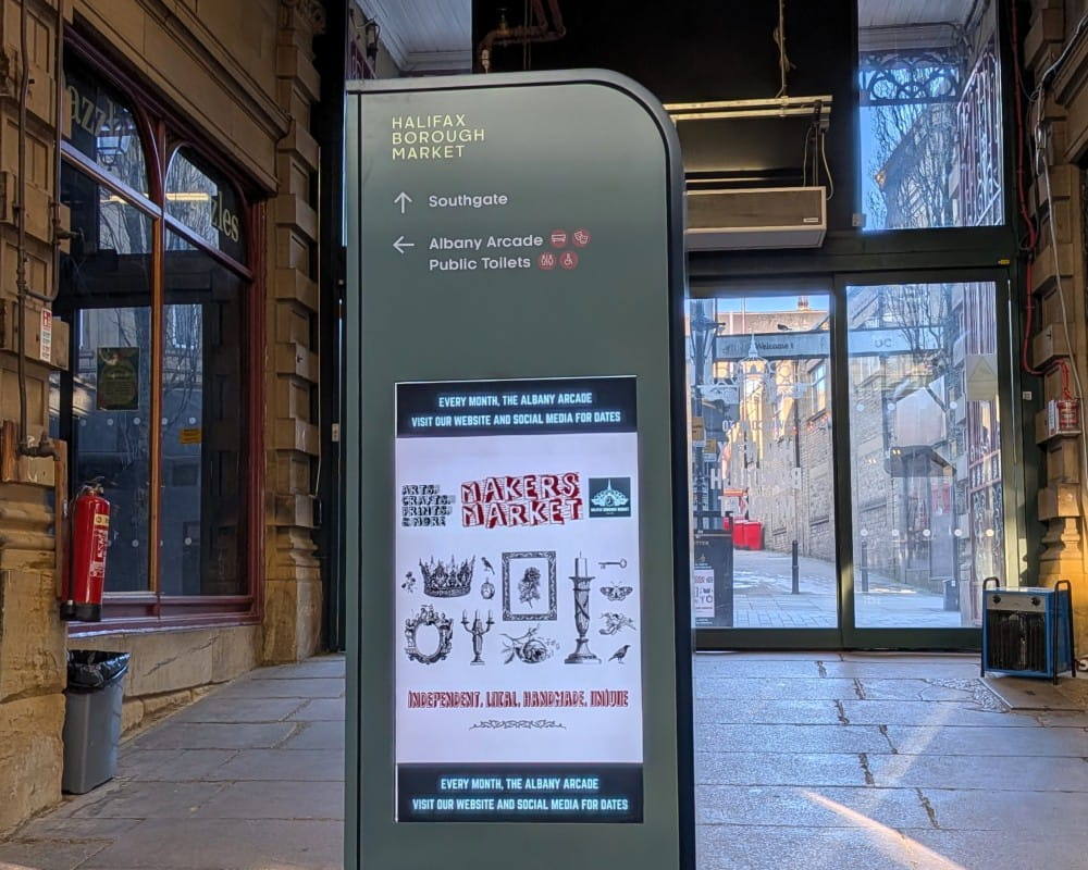 A digital totem at a market entrance.