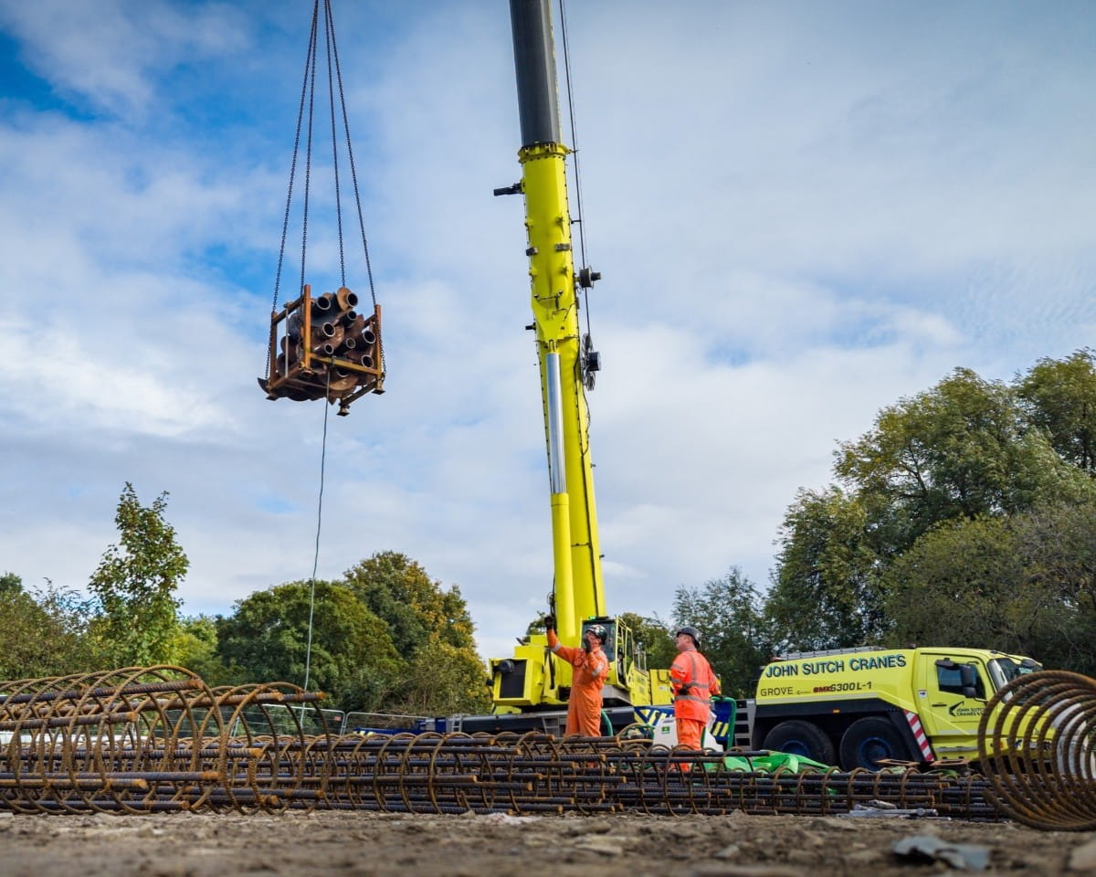 Directing the crane lift from the ground on site.