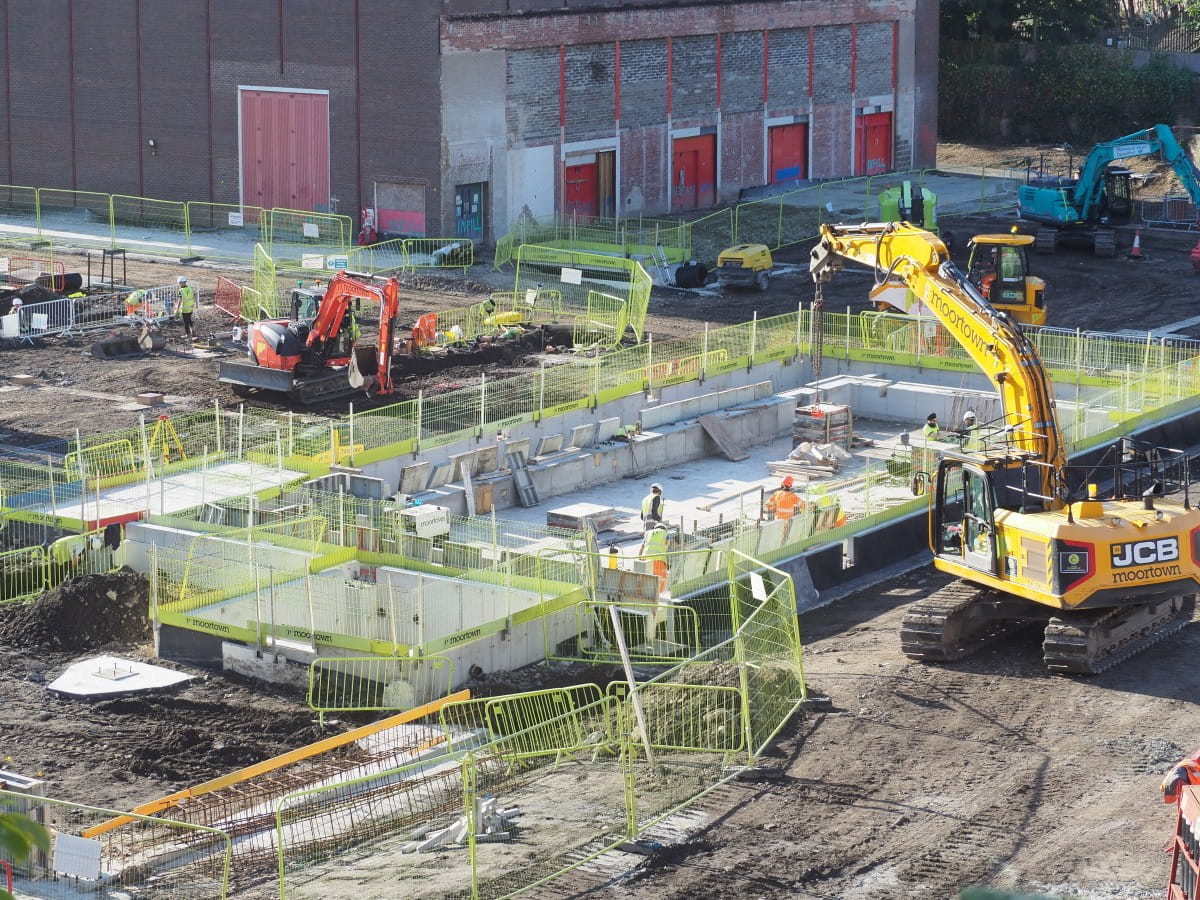 Construction workers prepare the base of the second pool.