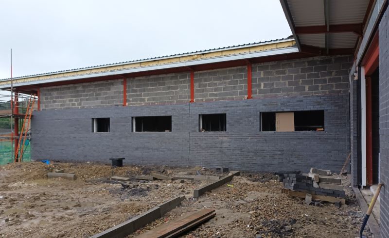 Close up showing the completed walls of the new Mixenden Community Hub which is halfway through construction.