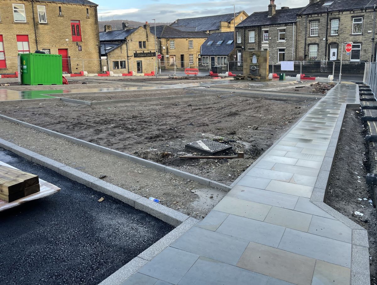 Newly installed paving. The paving surrounds an area which will be landscaped. 
