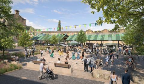 Bramsche Square event space in summertime. People sitting and walking through this area with the market canopy and stalls in the background. 